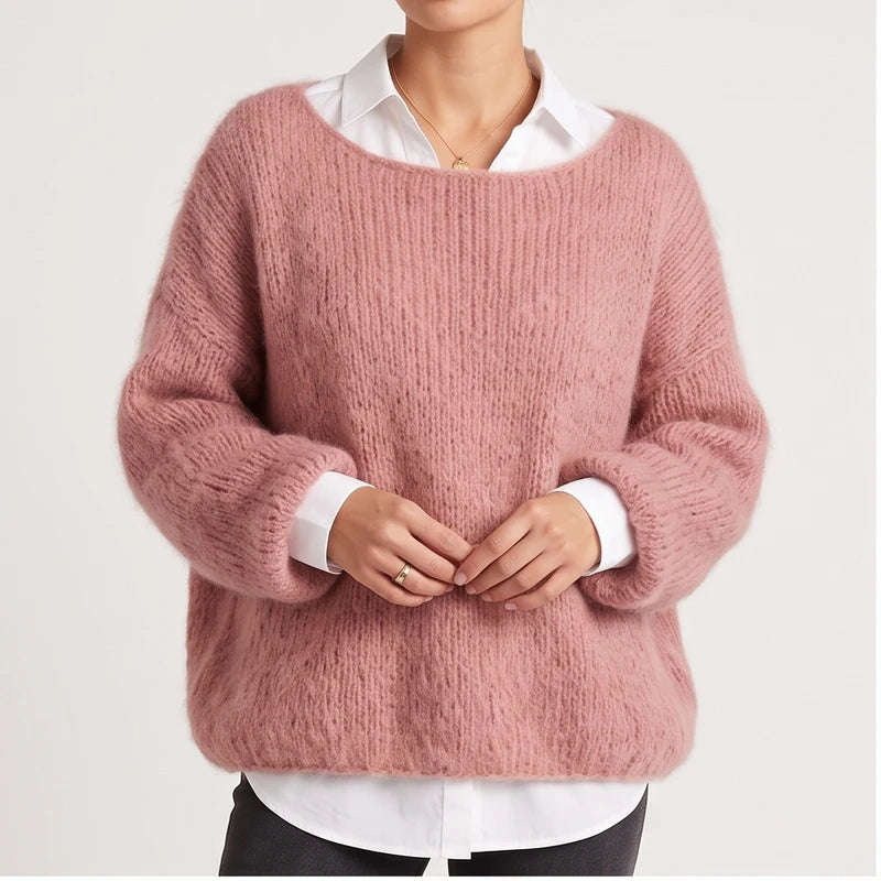 Model wearing pink knit pullover in a studio