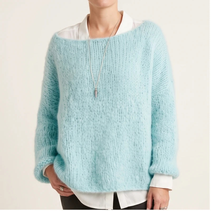 Model wearing blue knit pullover in a studio