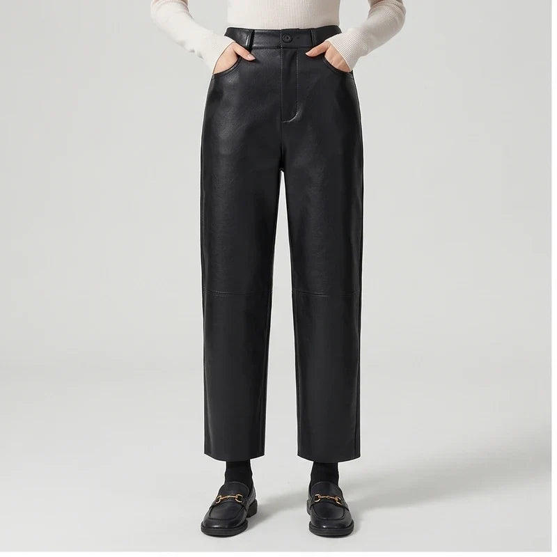 Black leather pants on an off-gray studio background