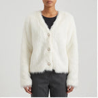 Model wearing white thicken knitted cardigan in a studio