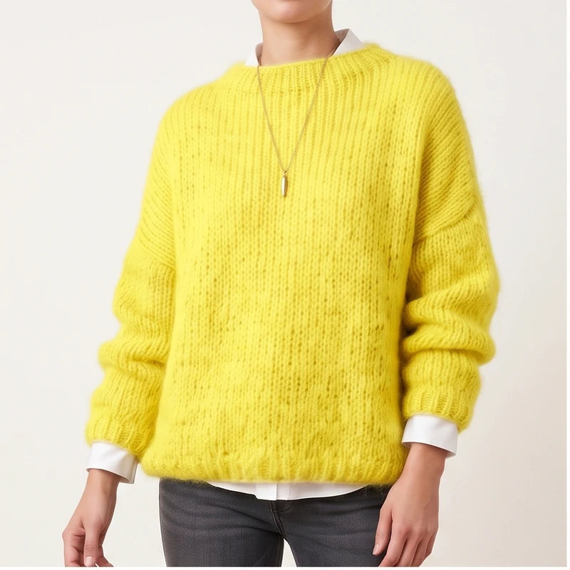 Model wearing yellow knit pullover in a studio