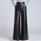 Black leather pants on an off-gray studio background