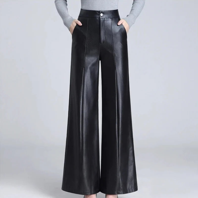 Black leather pants on an off-gray studio background