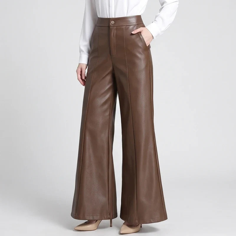 Coffee leather pants on an off-gray studio background