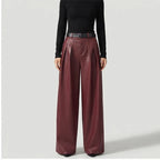 Red leather pants on an off-gray studio background