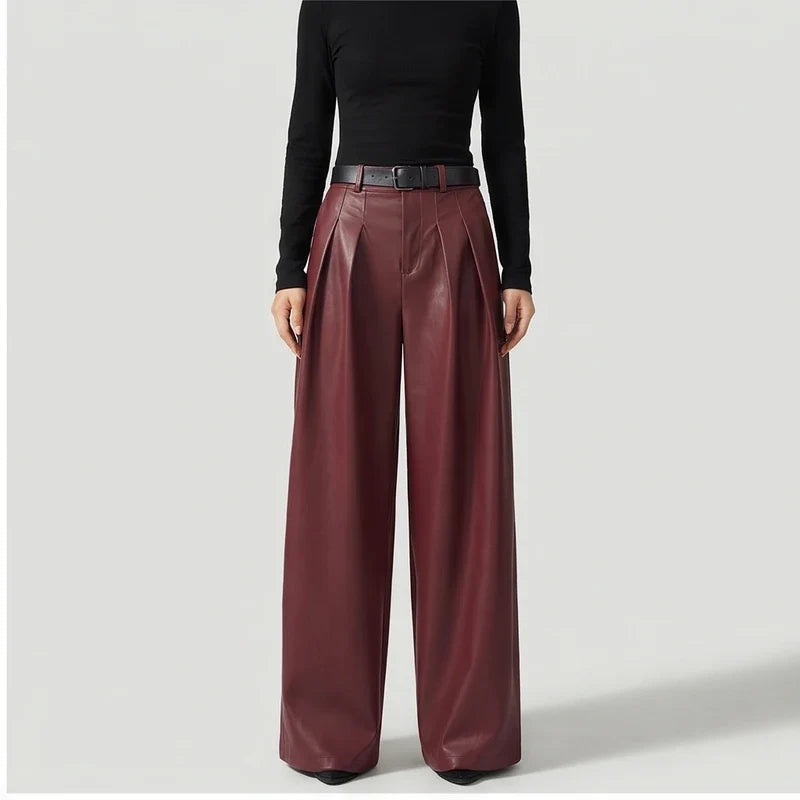 Red leather pants on an off-gray studio background