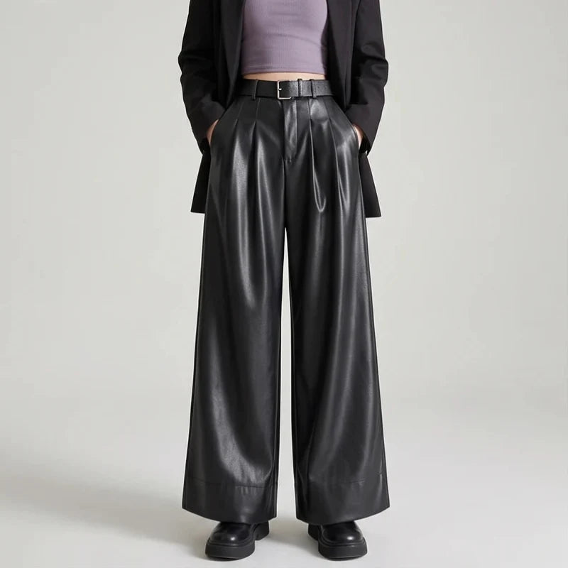Black leather pants on an off-gray studio background