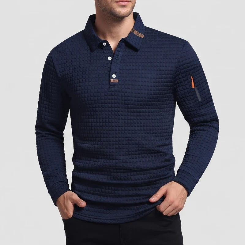 Man wearing a navy blue waffle-knit long-sleeve collared shirt with a three-button placket and arm zipper.