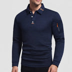 Man wearing a dark blue waffle-knit long-sleeve polo shirt with white buttons and an orange zipper pocket on the left arm.