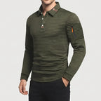 Man wearing an olive green waffle-knit long-sleeve polo with a three-button placket and a zipped pocket on the left sleeve.