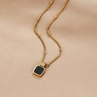 Solenne Gold Tone Black Stone Pendant Necklace