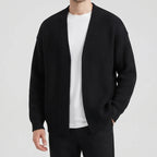 Black knit cardigan on an off-gray studio background