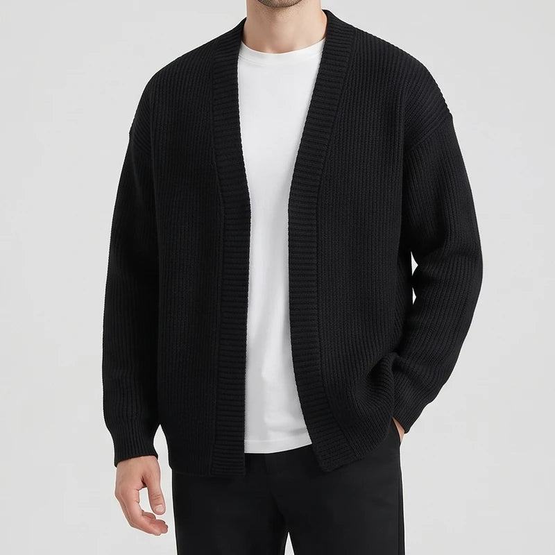Black knit cardigan on an off-gray studio background