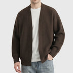 Brown knit cardigan on an off-gray studio background
