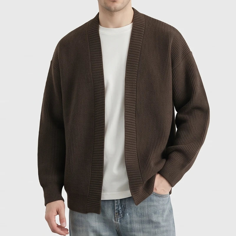 Brown knit cardigan on an off-gray studio background