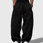 Black apparel on an off-gray studio background