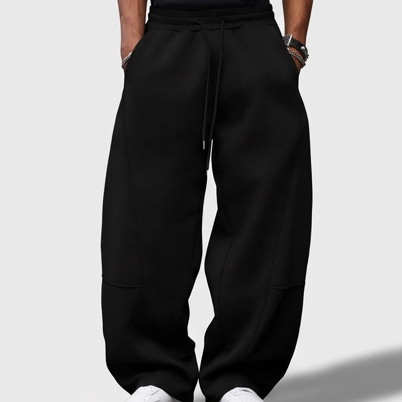Black apparel on an off-gray studio background