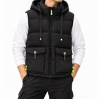 Man wearing a black puffer vest with a hood, neon yellow zippers, toggles, and front flap pockets over a white long-sleeve shirt.