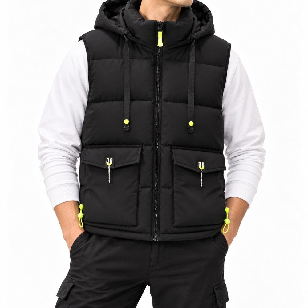 Man wearing a black puffer vest with a hood, neon yellow zippers, toggles, and front flap pockets over a white long-sleeve shirt.