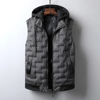 Dark gray men's puffer vest with a textured quilted pattern and black knit hood, displayed on a wooden hanger.