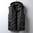 Black quilted puffer vest with a dark grey knit hooded insert and side pockets, hanging on a wooden hanger.