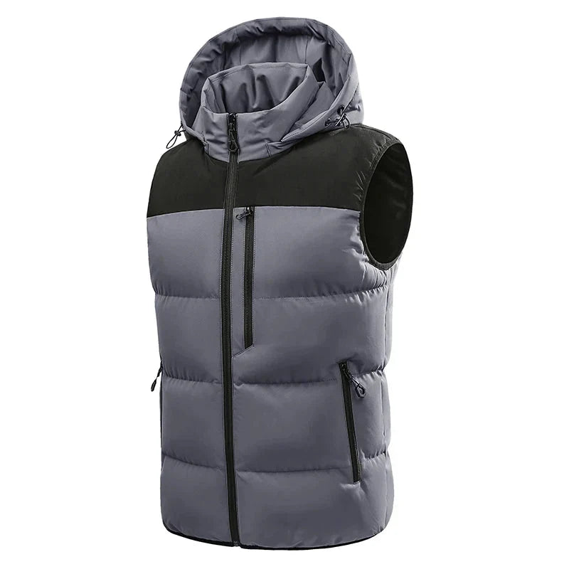 Two-tone grey and black puffer vest with a detachable hood, front zipper, and multiple zip pockets on a white background.