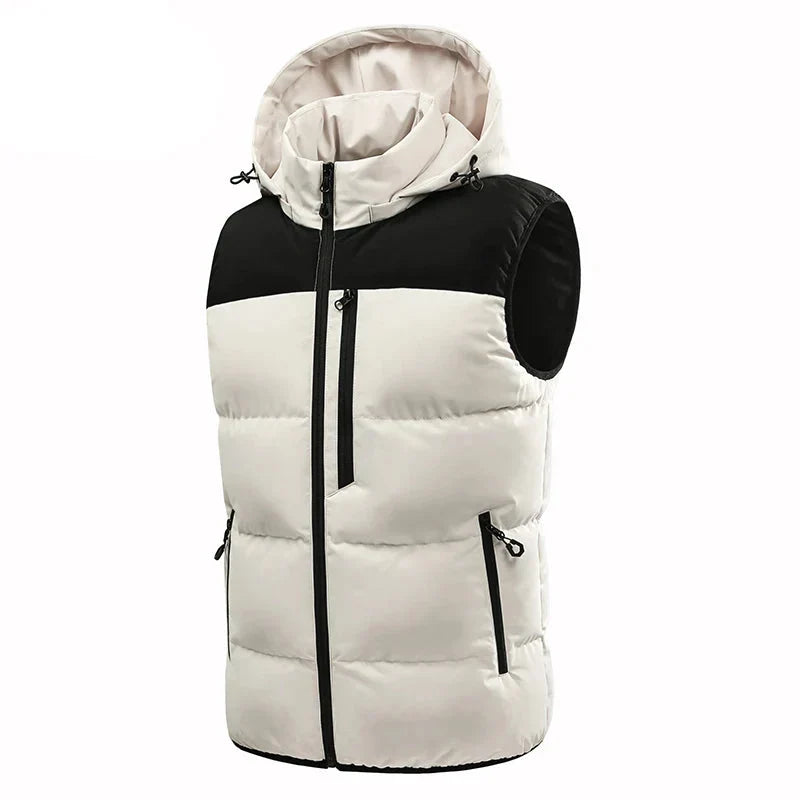 Two-tone puffer vest with a light cream body, black shoulder panel, attached hood, and multiple zippered pockets.