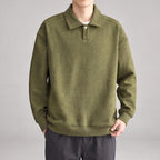 Man wearing a relaxed-fit olive green long-sleeve polo sweatshirt with a diagonal ribbed texture and a single button placket.