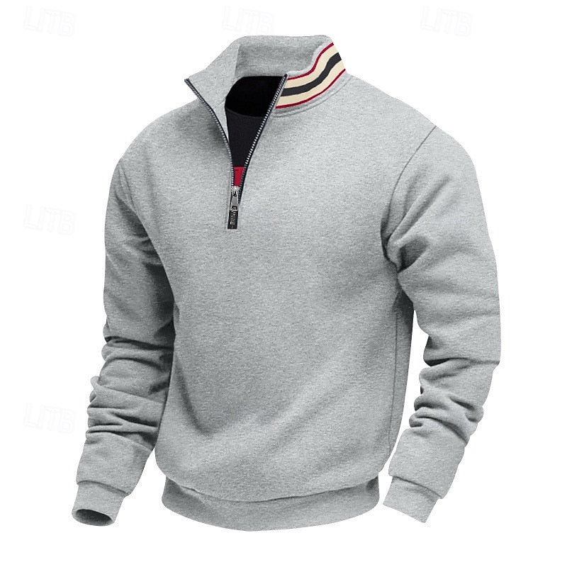 Gray quarter-zip sweatshirt with a partially open zipper revealing a black layer and a striped collar in red, black, and beige.