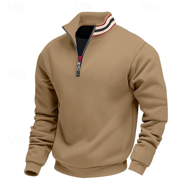 Tan quarter-zip sweatshirt with a stand-up striped collar, black and red lining, and a partially open silver zipper.