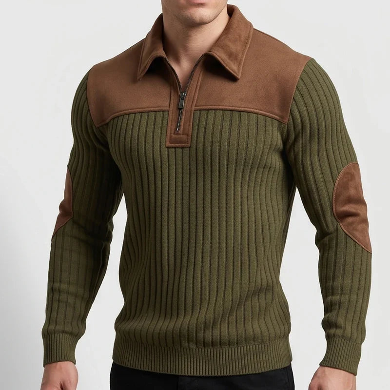 Man wearing an olive green ribbed knit quarter-zip jumper with brown suede collar, shoulder panels, and elbow patches, close-up.