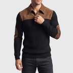 Man wearing a black ribbed knit quarter-zip jumper with a brown suede collar, shoulder panels, and elbow patches.