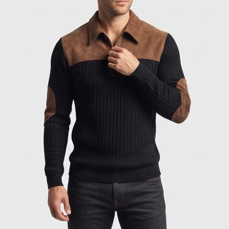 Man wearing a black ribbed knit quarter-zip jumper with a brown suede collar, shoulder panels, and elbow patches.
