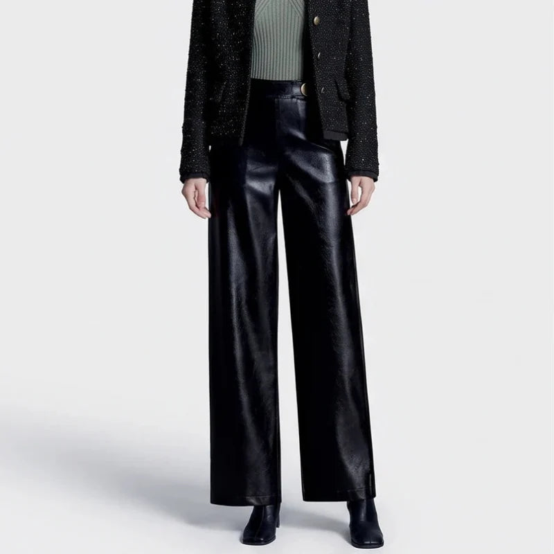 Black leather pants on an off-gray studio background