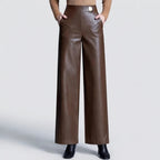 Coffee leather pants on an off-gray studio background