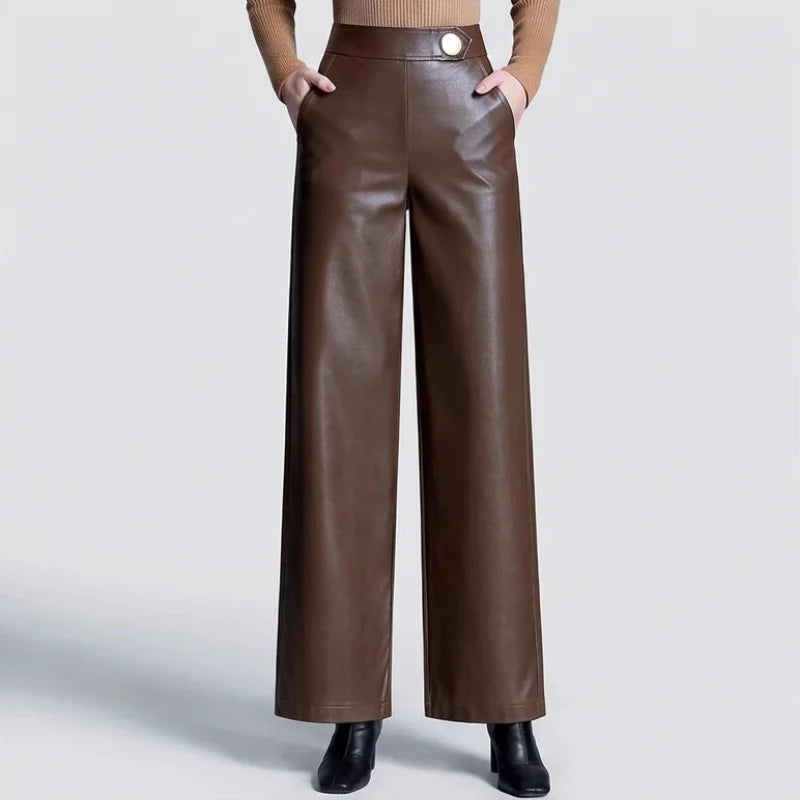 Coffee leather pants on an off-gray studio background