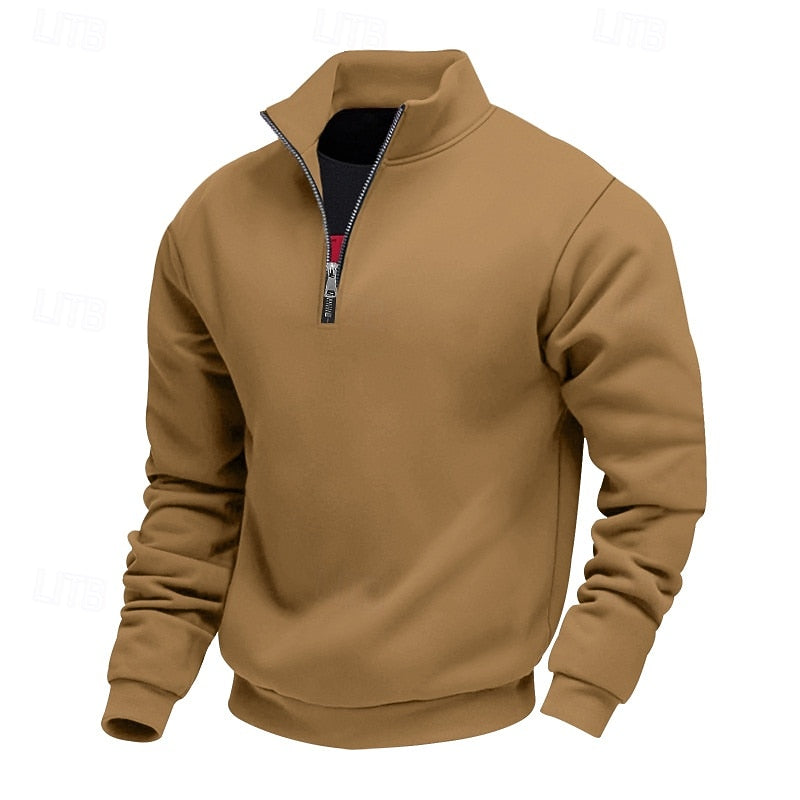 Tan quarter-zip sweatshirt with a standing collar, visible black undershirt, and a silver zipper pull on a white background.