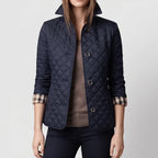 Navy jacket on an off-gray studio background