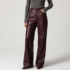 Brown leather pants on an off-gray studio background