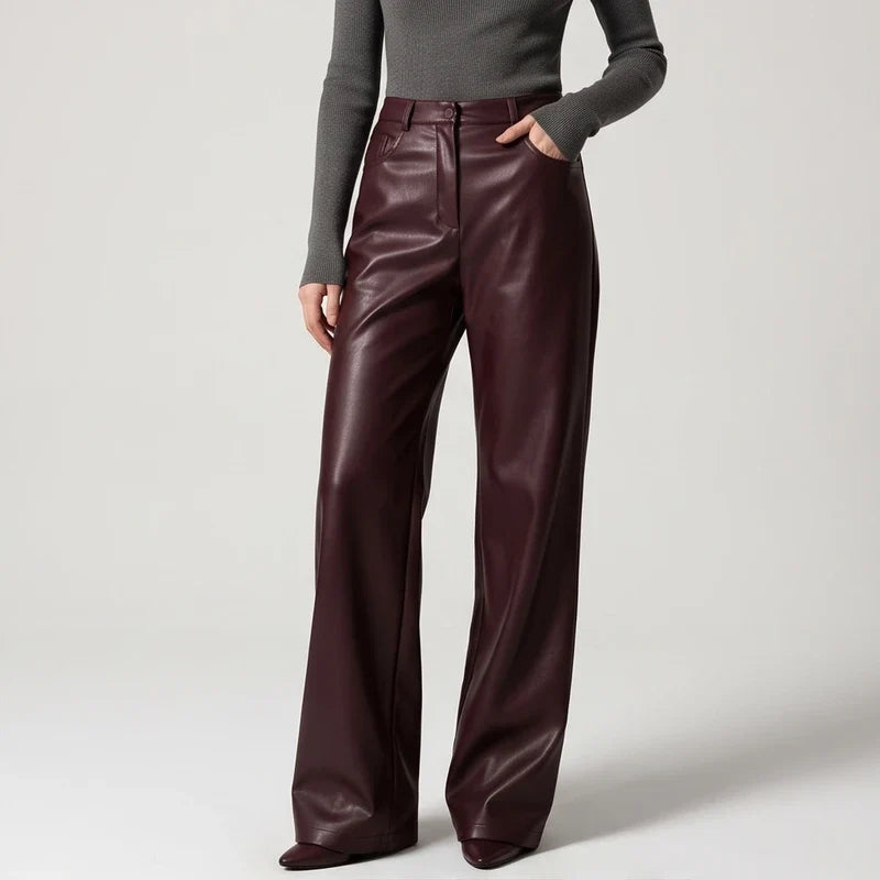 Brown leather pants on an off-gray studio background