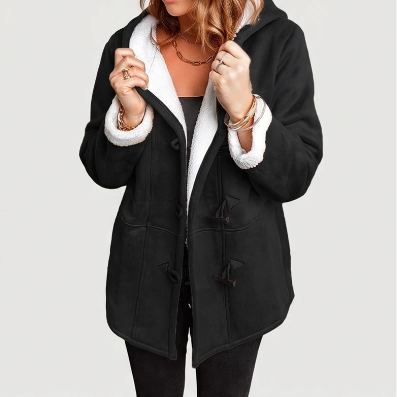 Woman wearing an open black hooded jacket with a white fuzzy borg lining and toggle closures.