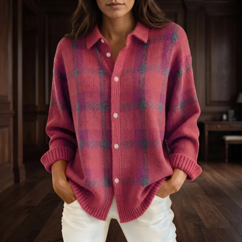 Woman wearing an oversized pink and purple plaid knit cardigan with a collar, white buttons, and ribbed cuffs.