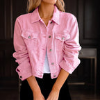 Woman wearing a pink denim jacket with silver buttons, chest pockets, and a pointed collar, over a white top.