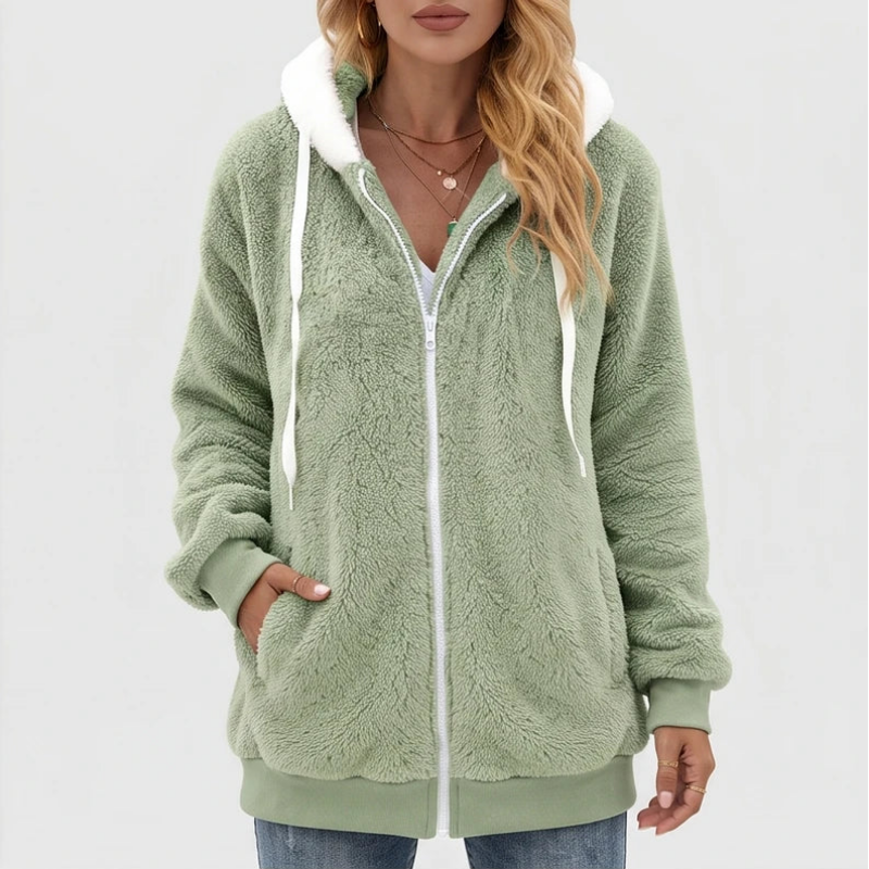 Woman wearing a fluffy light green full-zip hoodie with white drawstrings and a contrasting white hood lining.