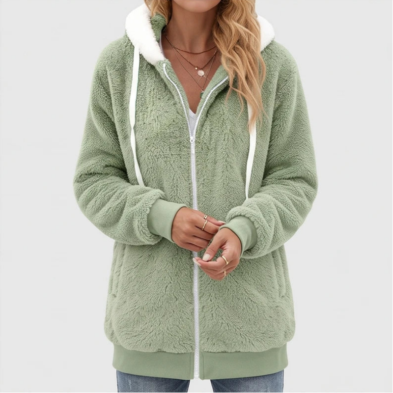 Woman wearing a light green fuzzy fleece hoodie with a white zipper, drawstring, and white hood lining.