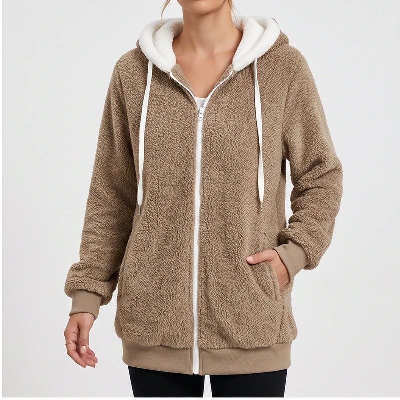 Woman wearing a fluffy brown fleece zip-up hoodie with a white hood lining, white drawstring, and ribbed cuffs.