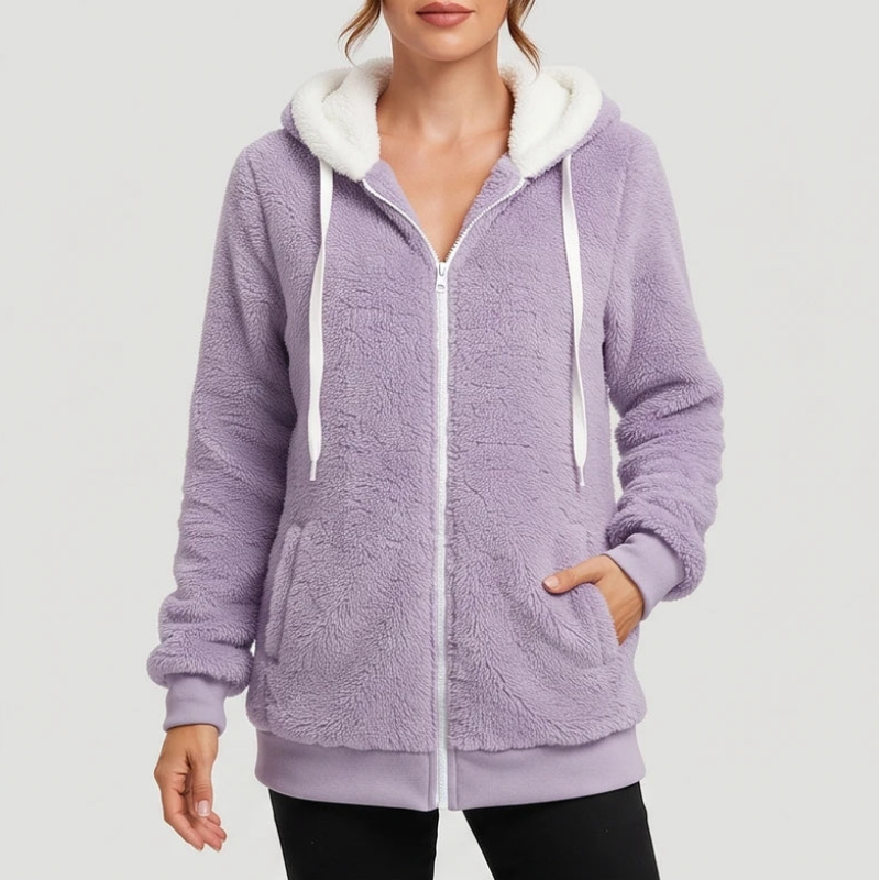 Woman wearing a light purple sherpa fleece full-zip hoodie with white lining and drawstrings, hands in pockets.