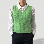 Green knit sweater on an off-gray studio background