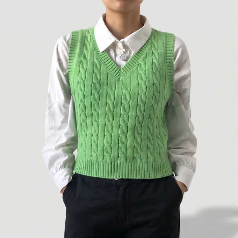 Green knit sweater on an off-gray studio background