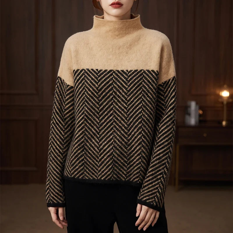 Woman wearing a beige roll neck jumper with a black and beige herringbone pattern across the chest and sleeves.